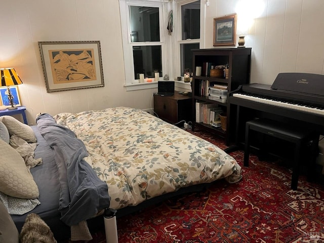 bedroom featuring wood walls