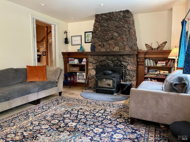 living room featuring a wood stove and light hardwood / wood-style flooring