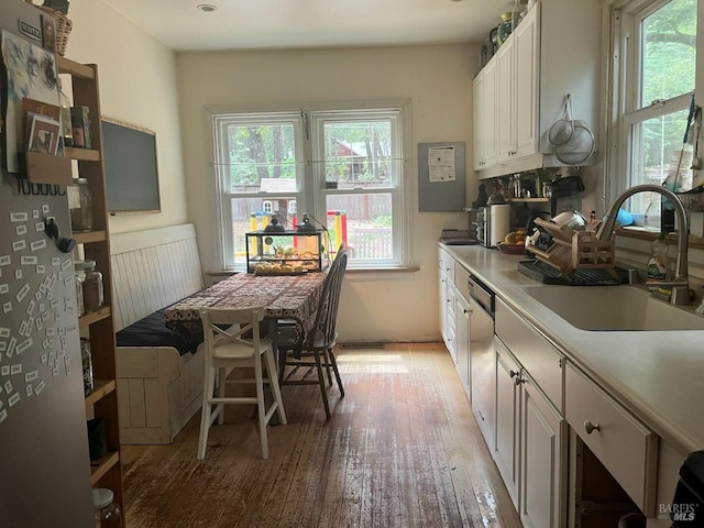 kitchen featuring light hardwood / wood-style floors, white cabinetry, and sink