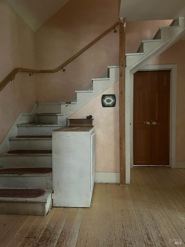 stairway featuring hardwood / wood-style flooring