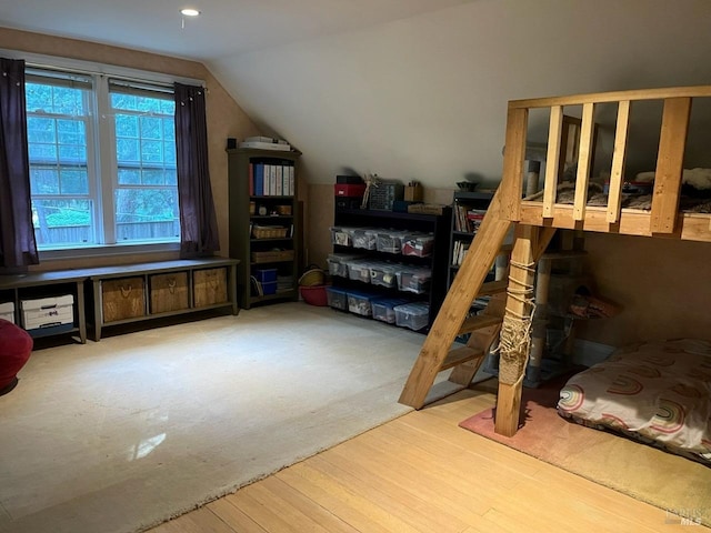 interior space featuring hardwood / wood-style flooring and vaulted ceiling