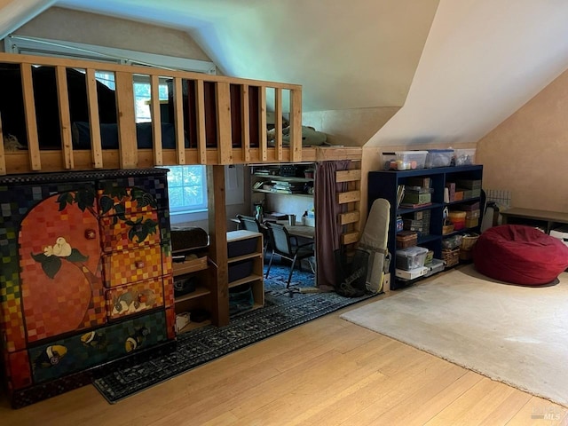 interior space featuring vaulted ceiling and hardwood / wood-style flooring