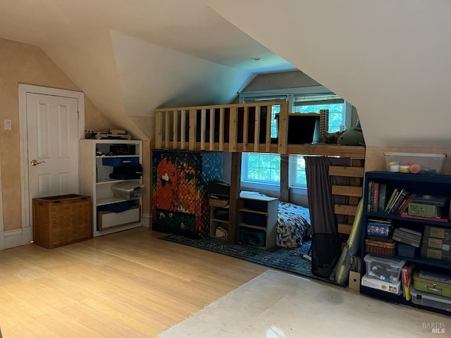 bedroom featuring wood-type flooring and vaulted ceiling