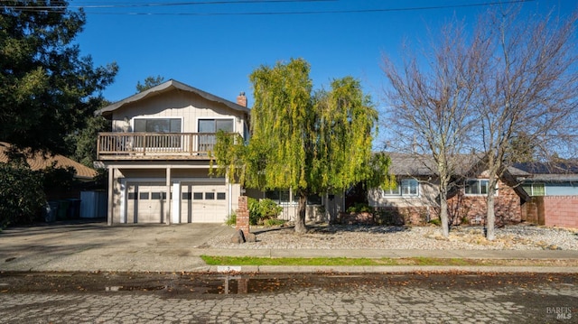 view of front of house featuring a garage and a balcony