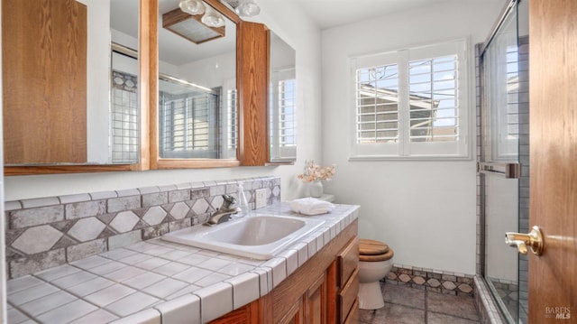 bathroom with walk in shower, tile patterned flooring, vanity, and toilet