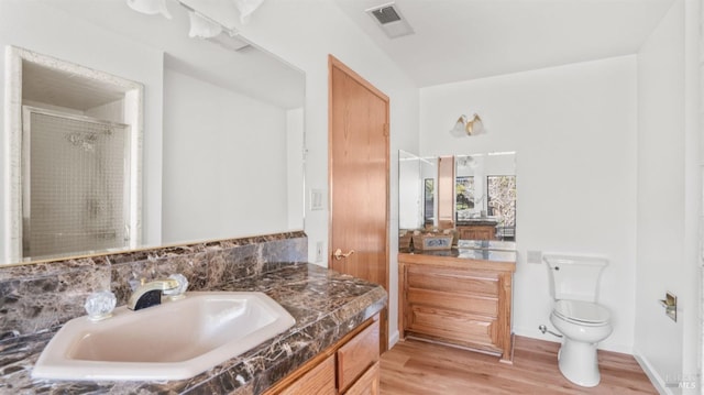 bathroom with hardwood / wood-style flooring, vanity, and toilet