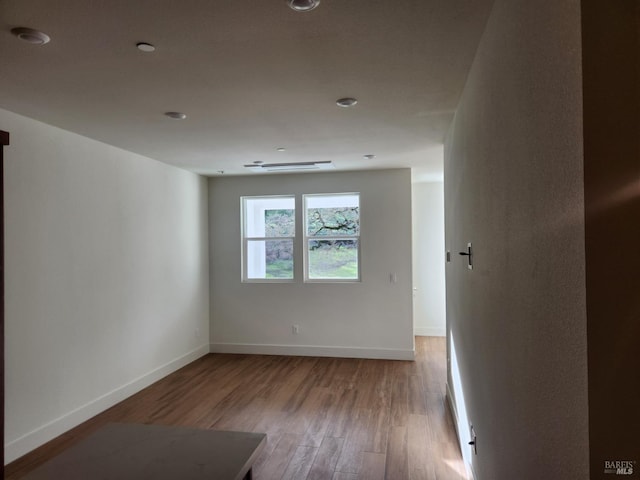 empty room with hardwood / wood-style flooring