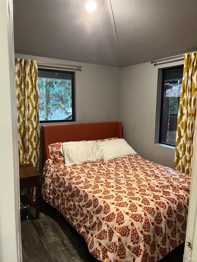 bedroom featuring a textured ceiling and hardwood / wood-style flooring