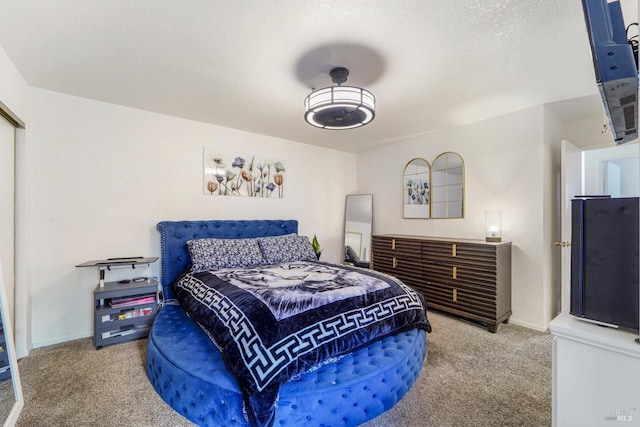 carpeted bedroom featuring a textured ceiling and baseboards