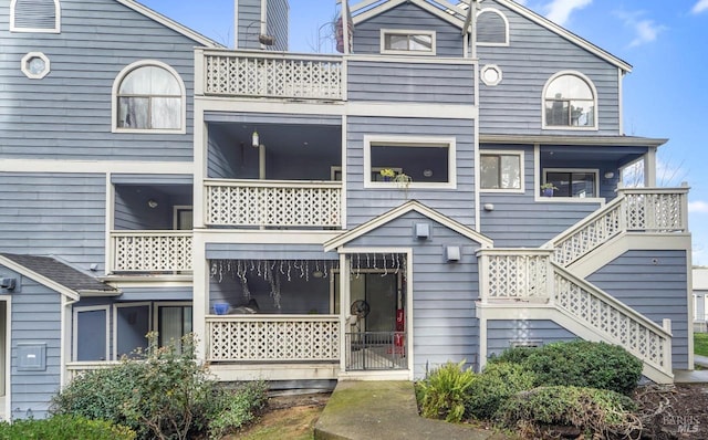 view of front of property featuring stairway