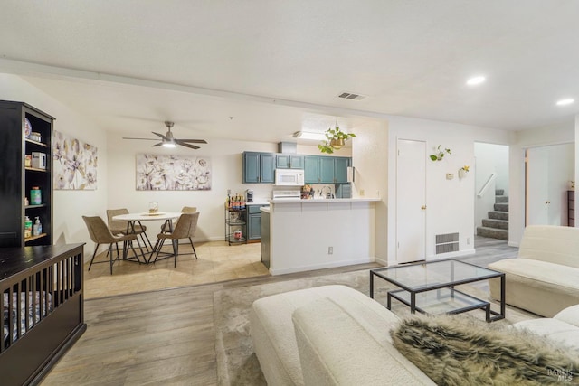 living room featuring stairway, recessed lighting, visible vents, and baseboards