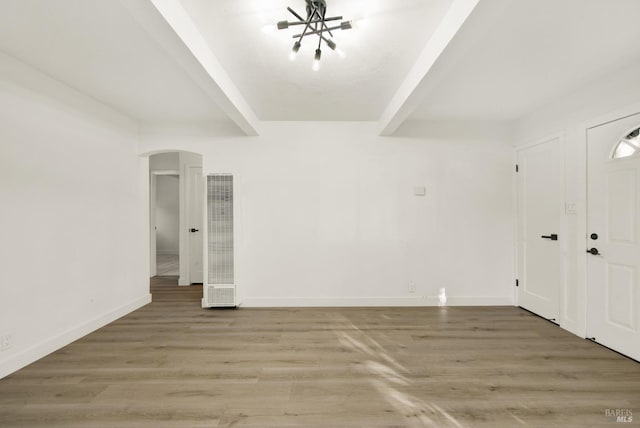 entrance foyer featuring beamed ceiling and hardwood / wood-style floors