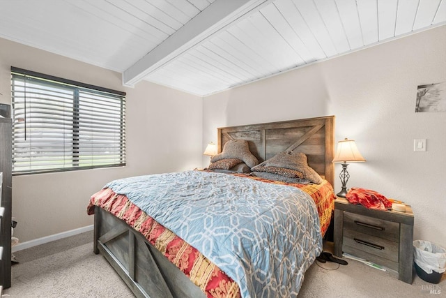 carpeted bedroom featuring beam ceiling