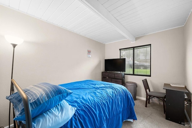 carpeted bedroom featuring beamed ceiling