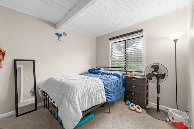 carpeted bedroom with beam ceiling