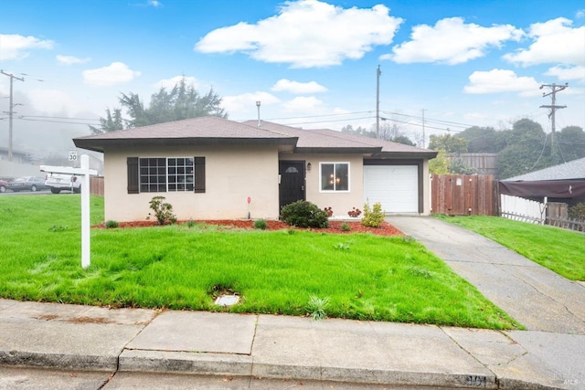 view of front of property featuring a front lawn and a garage