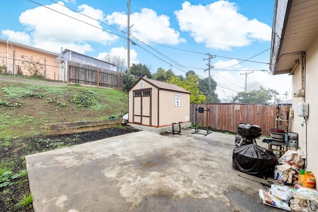 view of patio featuring a storage unit