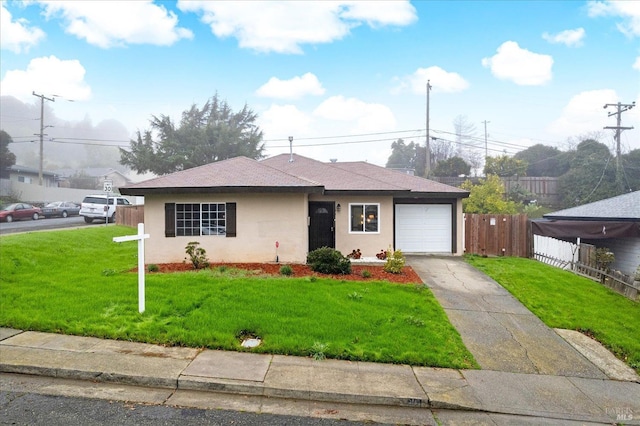 view of front of property with a garage and a front yard