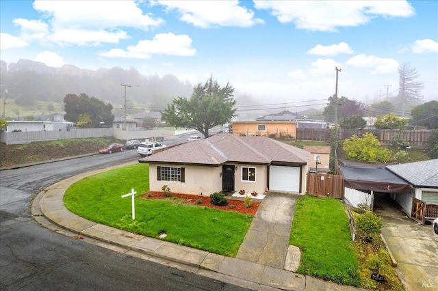 view of front facade featuring a garage and a front lawn