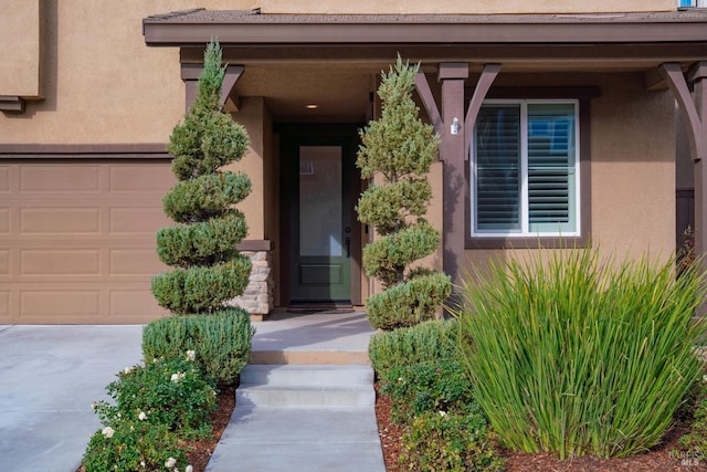 view of exterior entry with a garage