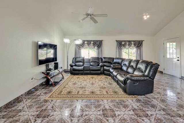 living room featuring ceiling fan and lofted ceiling