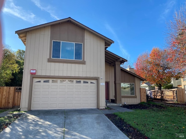 view of front facade featuring a garage, concrete driveway, fence, board and batten siding, and a front yard