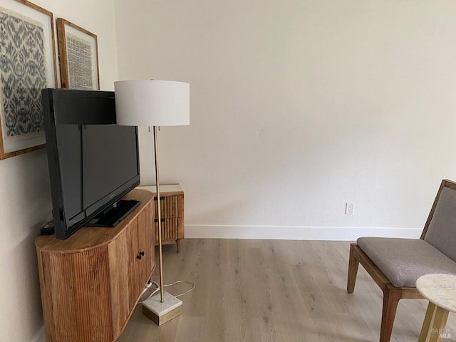 sitting room featuring light wood-type flooring and baseboards