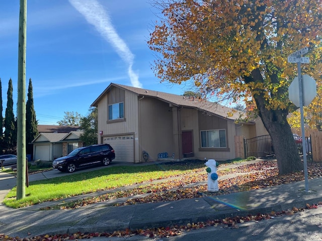 view of front of home with a garage and a front lawn