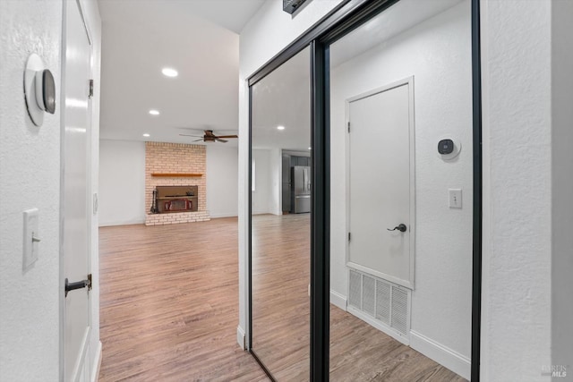 hallway with light hardwood / wood-style floors