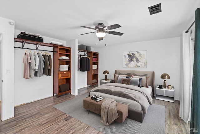 bedroom with ceiling fan and hardwood / wood-style floors