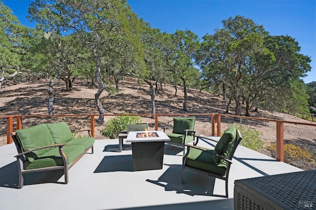 view of patio / terrace featuring an outdoor living space with a fire pit