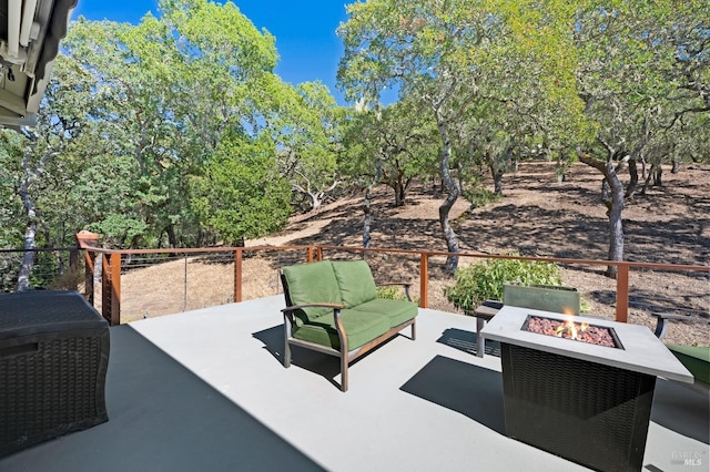 view of patio featuring an outdoor living space with a fire pit