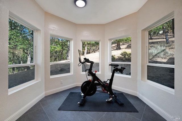 workout area featuring dark tile patterned flooring