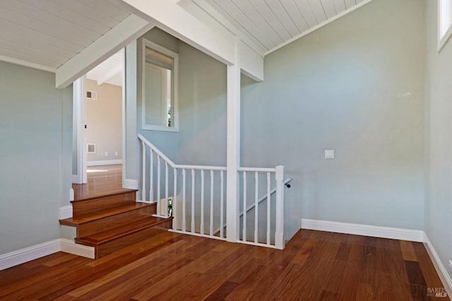 stairs featuring vaulted ceiling with beams and wood-type flooring