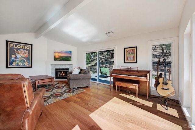 living room featuring lofted ceiling with beams and wood-type flooring