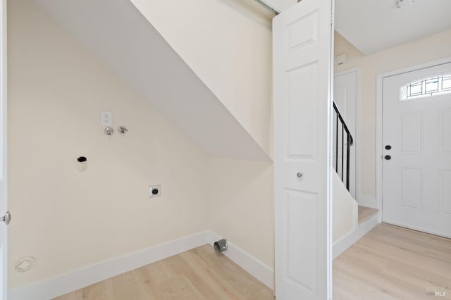 clothes washing area featuring light hardwood / wood-style floors and hookup for an electric dryer