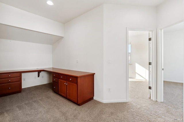 unfurnished office with light colored carpet and built in desk