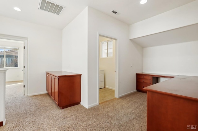 interior space featuring light carpet and washer / clothes dryer