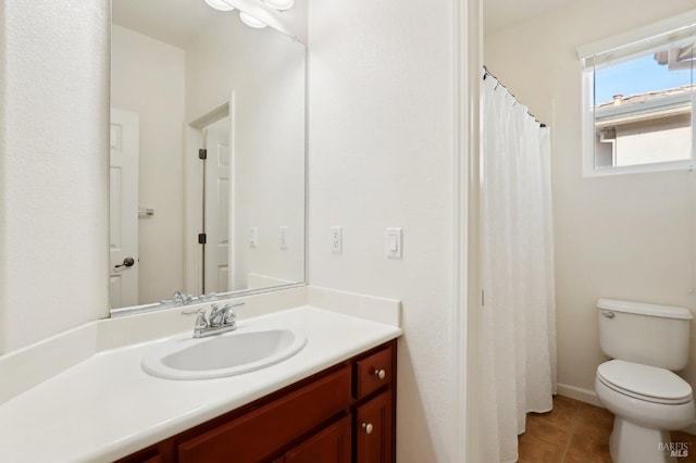 bathroom featuring tile patterned floors, vanity, and toilet