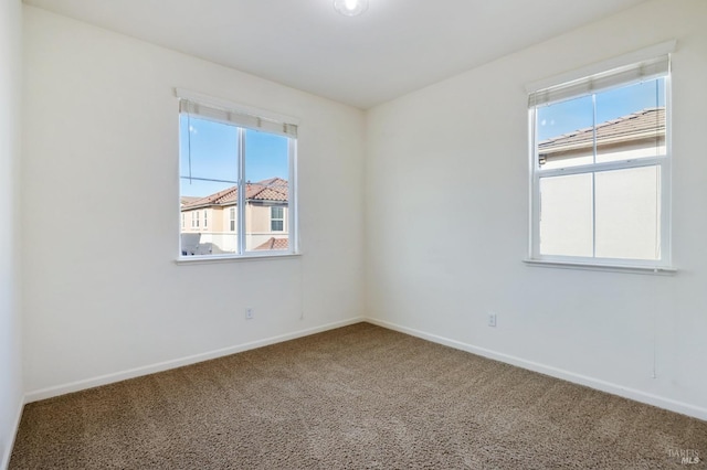 unfurnished room featuring carpet flooring and a healthy amount of sunlight