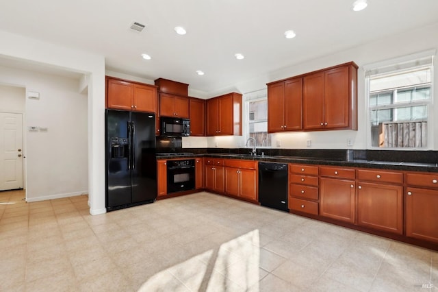 kitchen featuring sink, a wealth of natural light, and black appliances