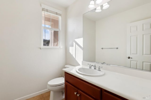 bathroom with tile patterned flooring, vanity, and toilet