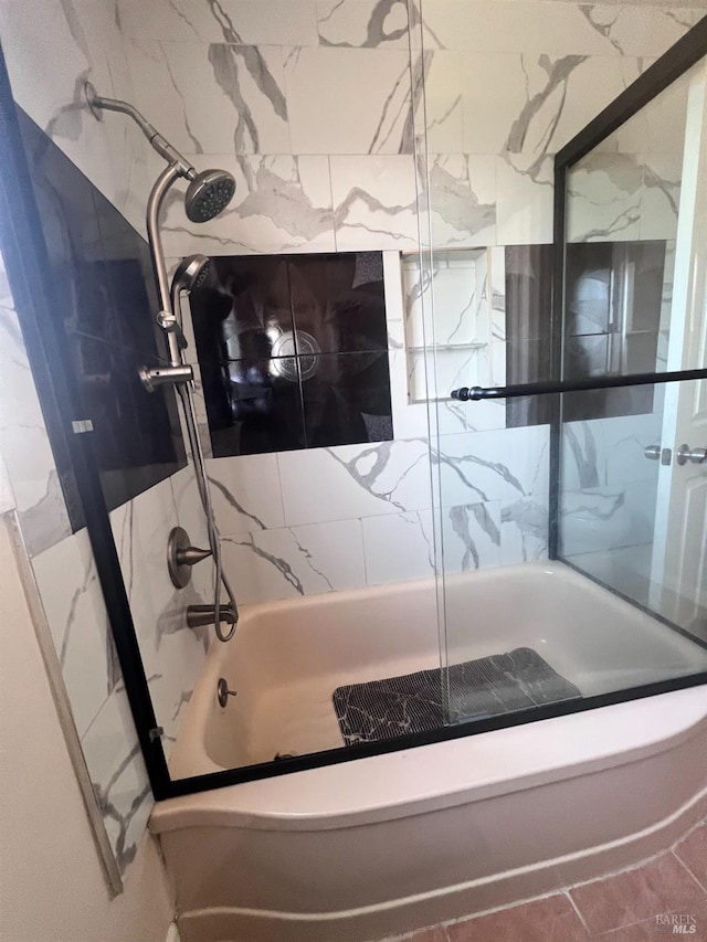 bathroom featuring combined bath / shower with glass door