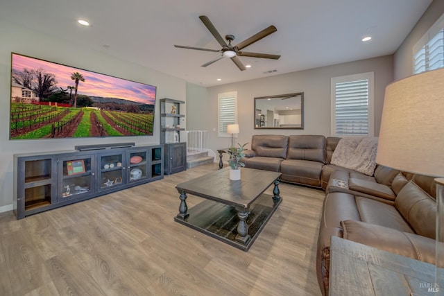 living room featuring light wood-type flooring and ceiling fan