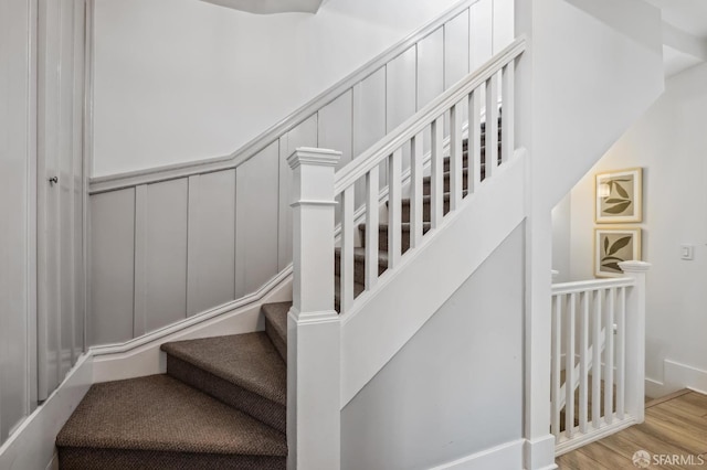 stairs with hardwood / wood-style flooring