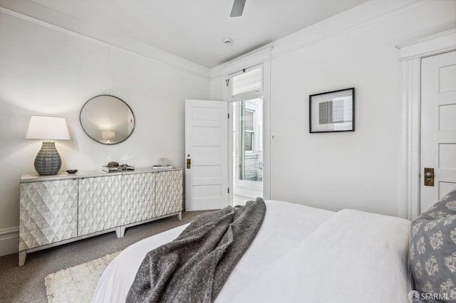 carpeted bedroom featuring ceiling fan and ornamental molding