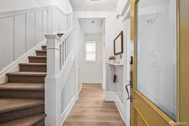 staircase with hardwood / wood-style floors