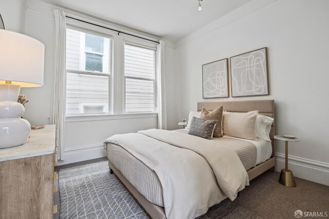 bedroom featuring crown molding and multiple windows