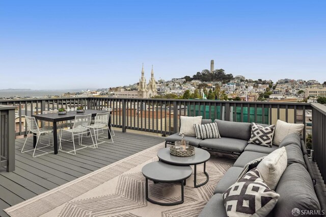 deck featuring a water view and an outdoor living space