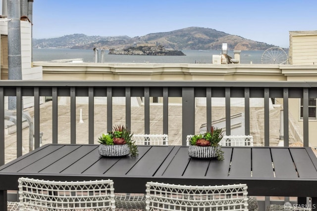 balcony with a water and mountain view